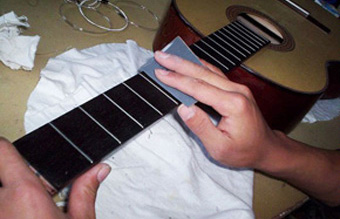 Hand Polishing the Frets and Fretboard.